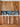 Walnut upper cabinets and lower drawers. Natural wood grain. Blue tile backsplash.