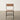 Wooden chair with metal frame on a wooden floor against a white wall